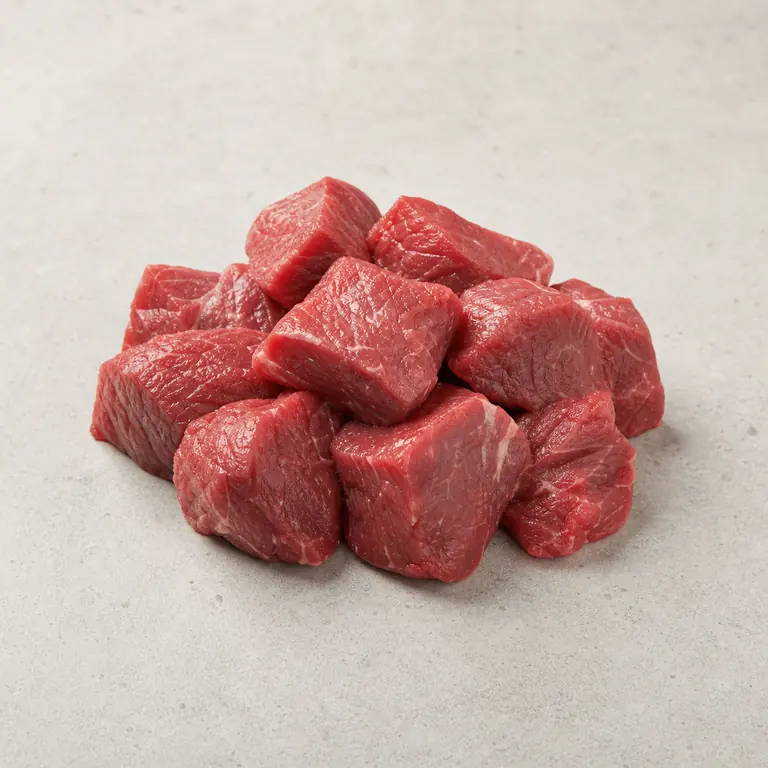 Beef stew meat (raw) on a neutral surface