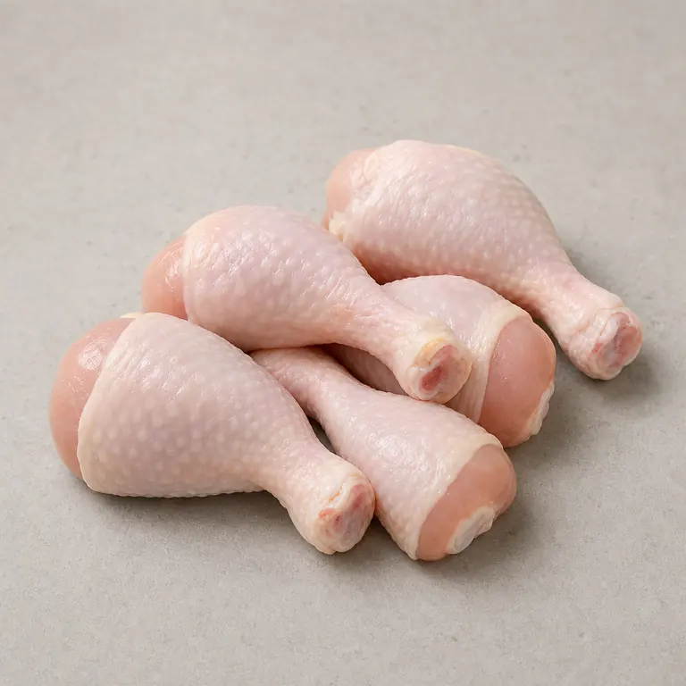 Chicken drumsticks (raw) on a neutral surface