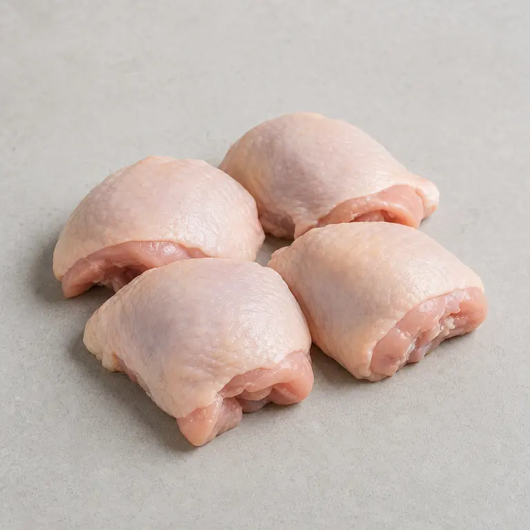 Chicken thighs (raw) on a neutral surface