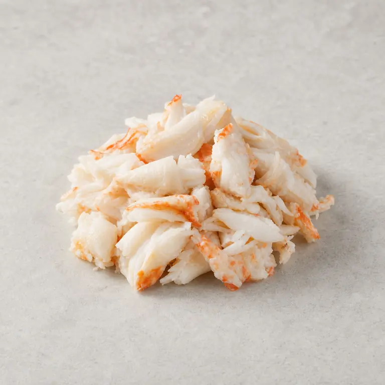 Crab meat (cooked) on a neutral surface