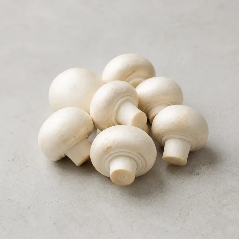 Mushrooms (raw) on a neutral surface
