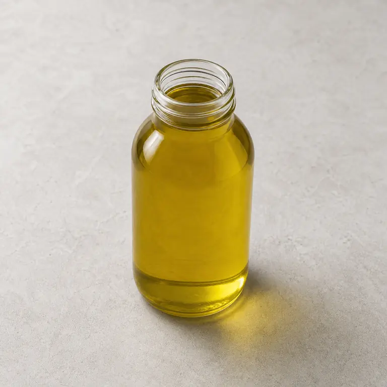 Olive oil (opened) on a neutral surface
