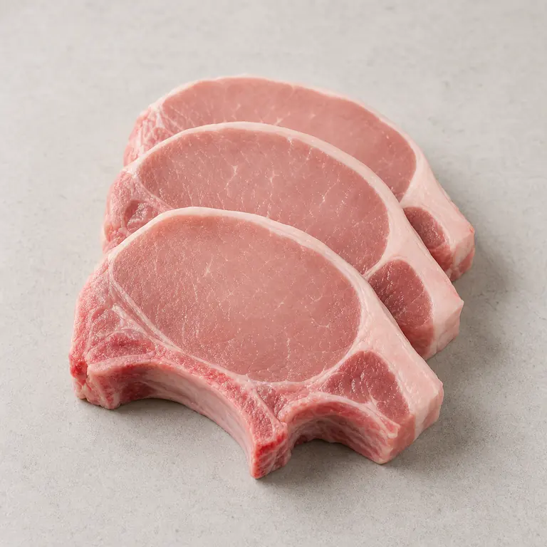 Pork chops (raw) on a neutral surface