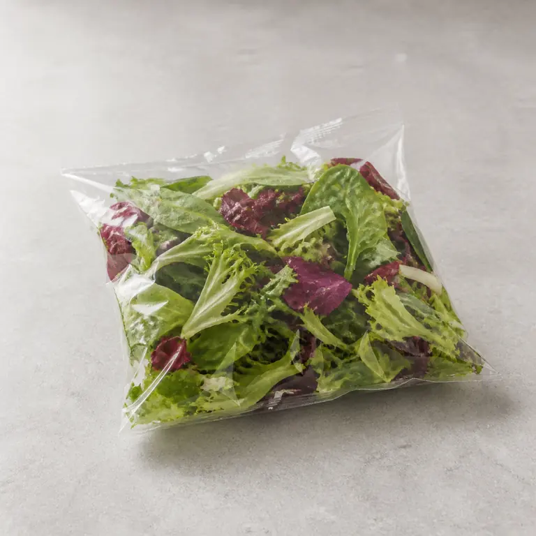 Prepared salad (bagged) on a neutral surface