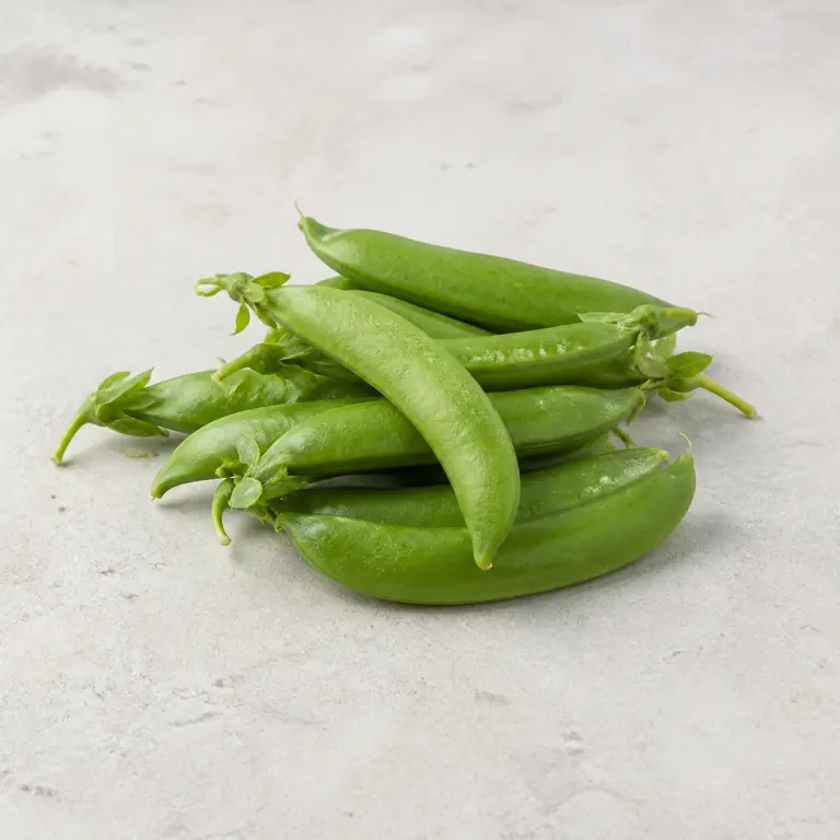 Sugar snap peas on a neutral surface